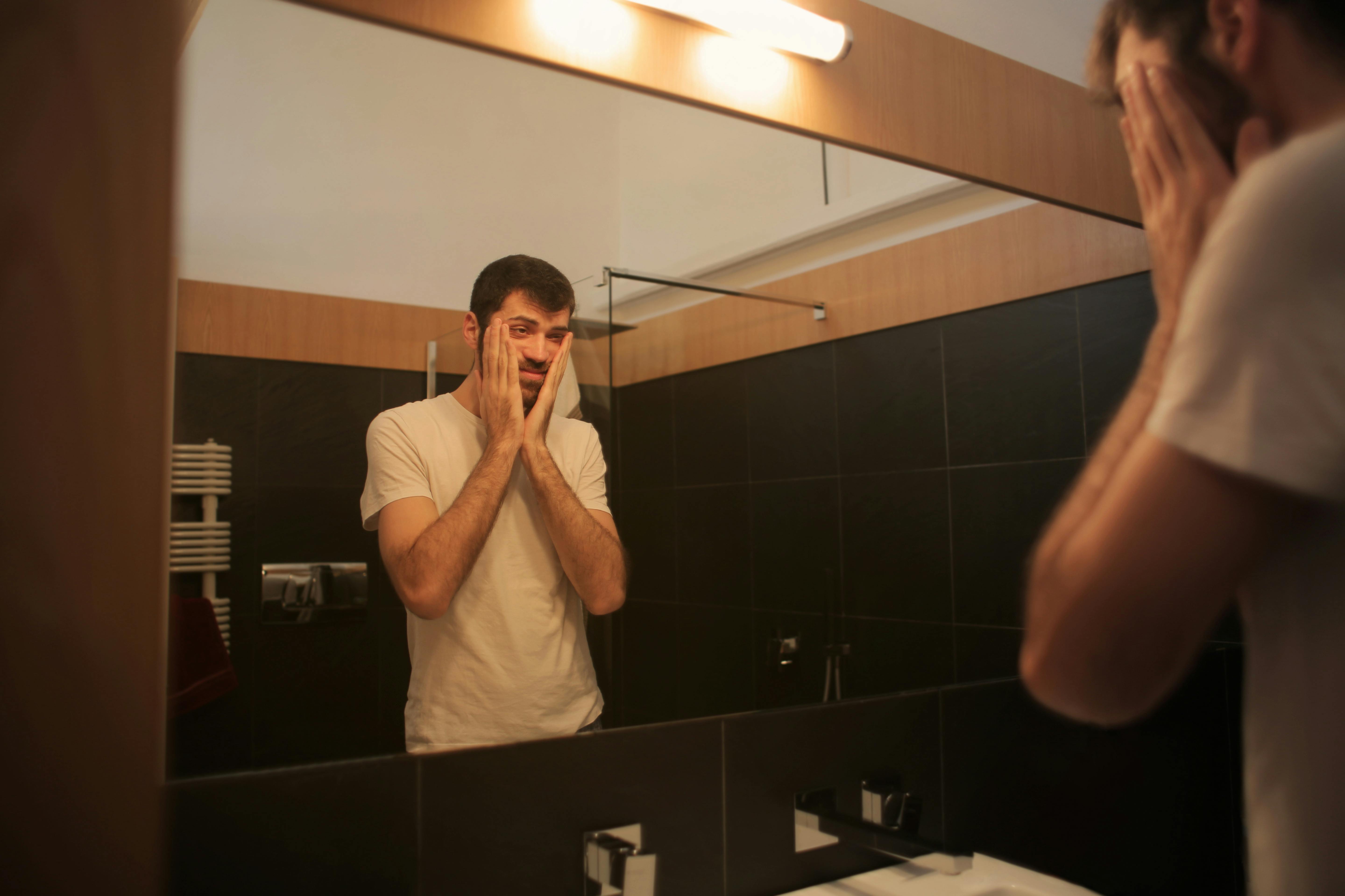 Man looking at a mirror