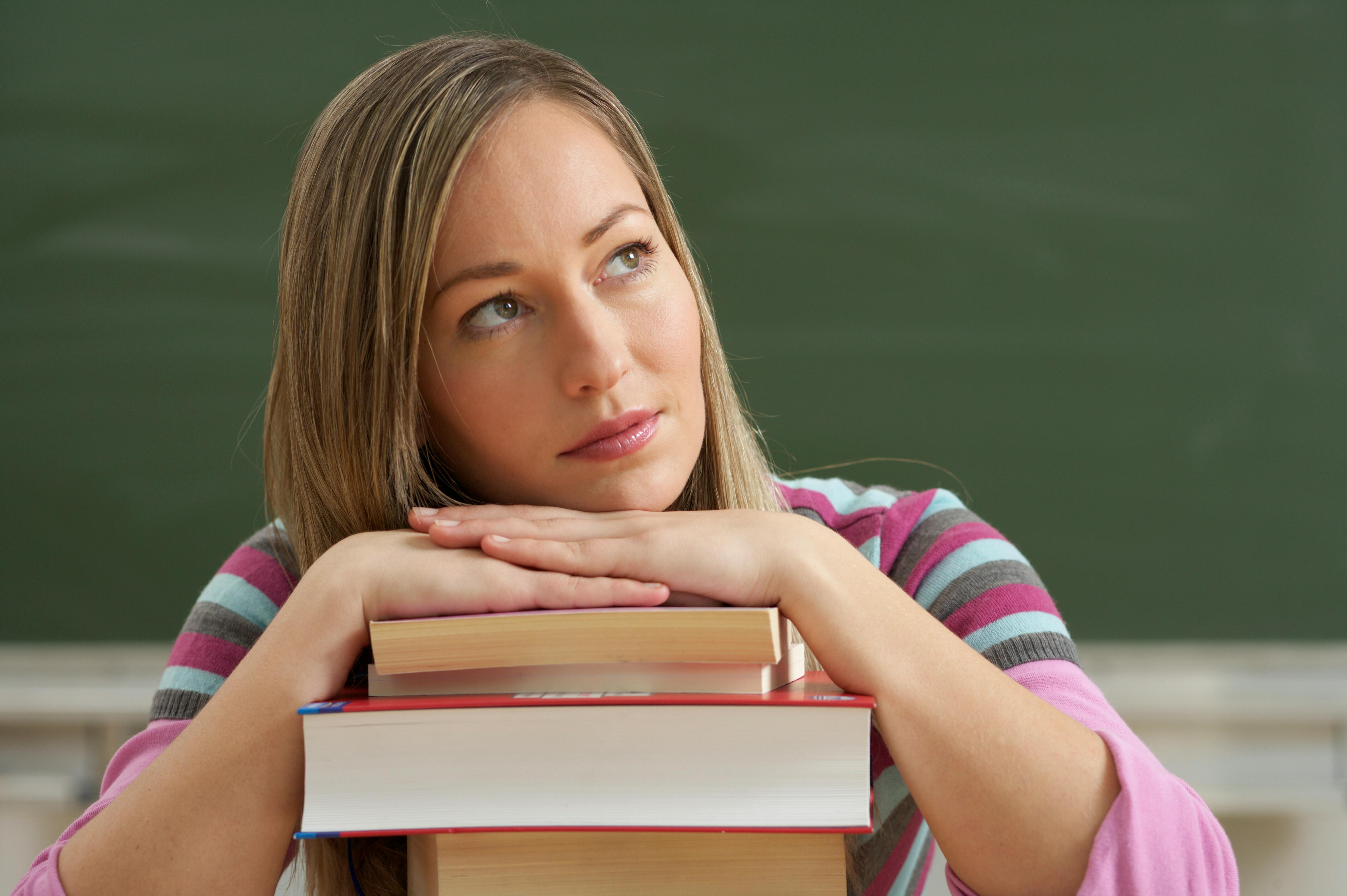 Girl thinking over a book