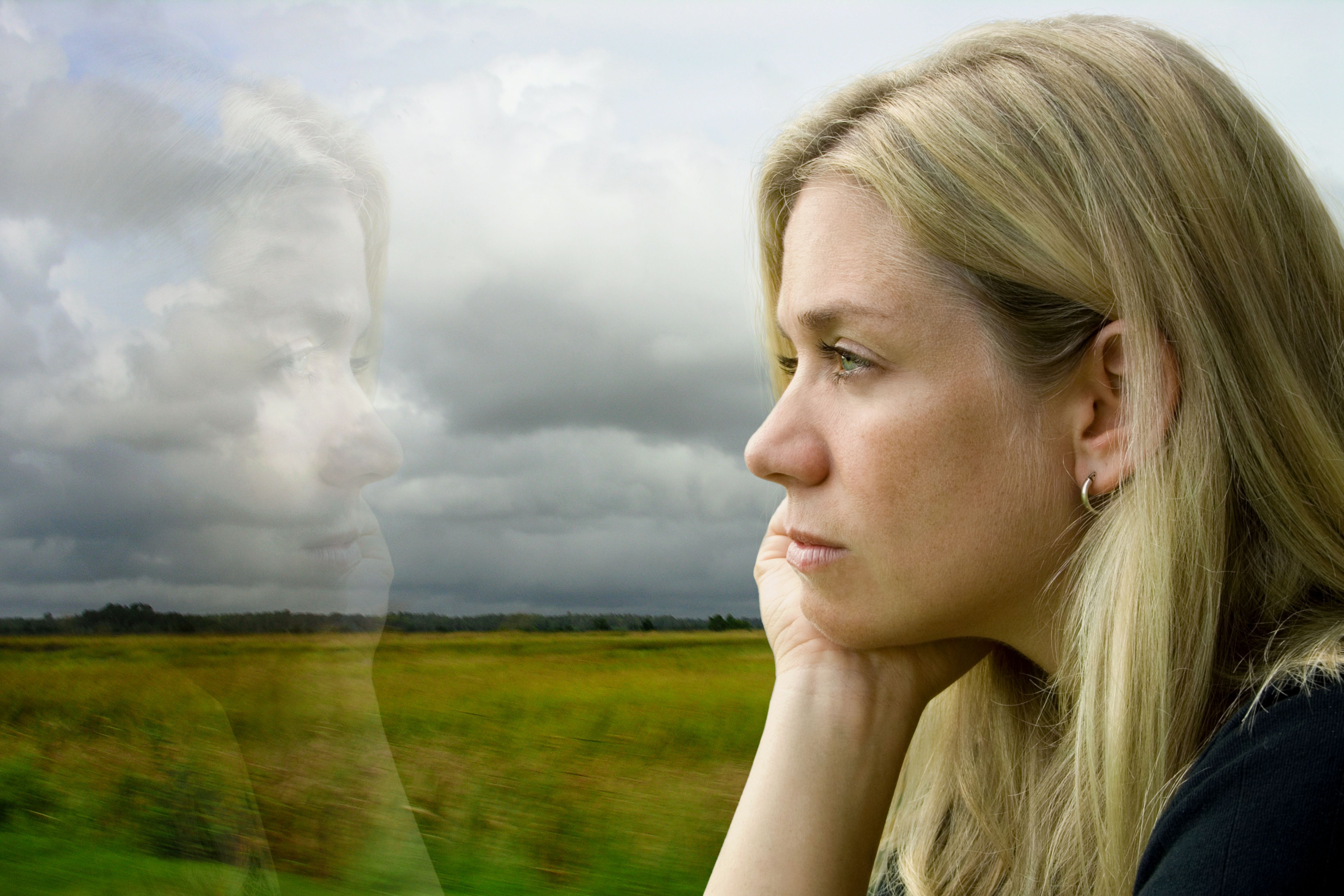A woman in reflection by the window