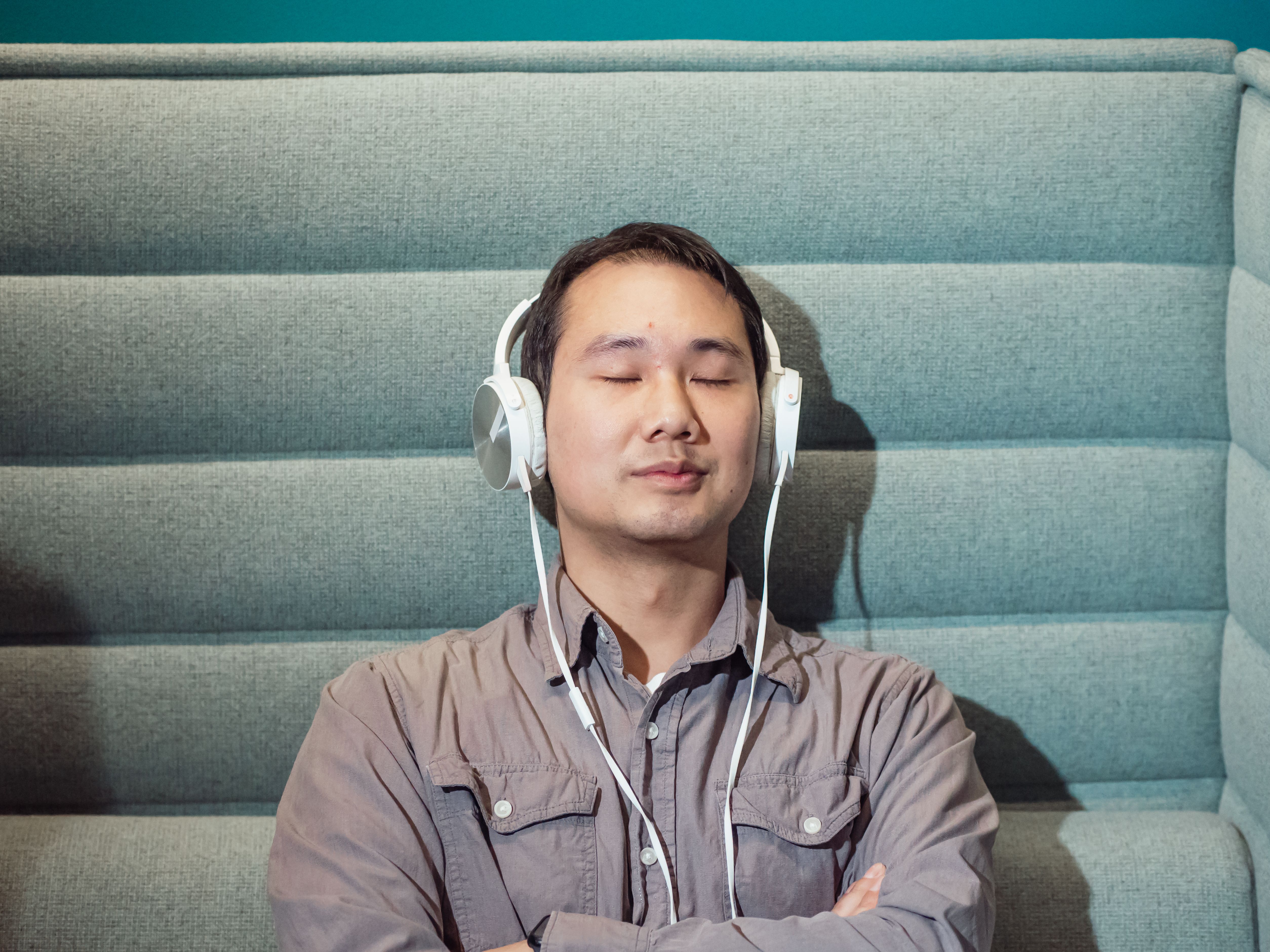 Man relaxing listening to sound frequencies with headphones